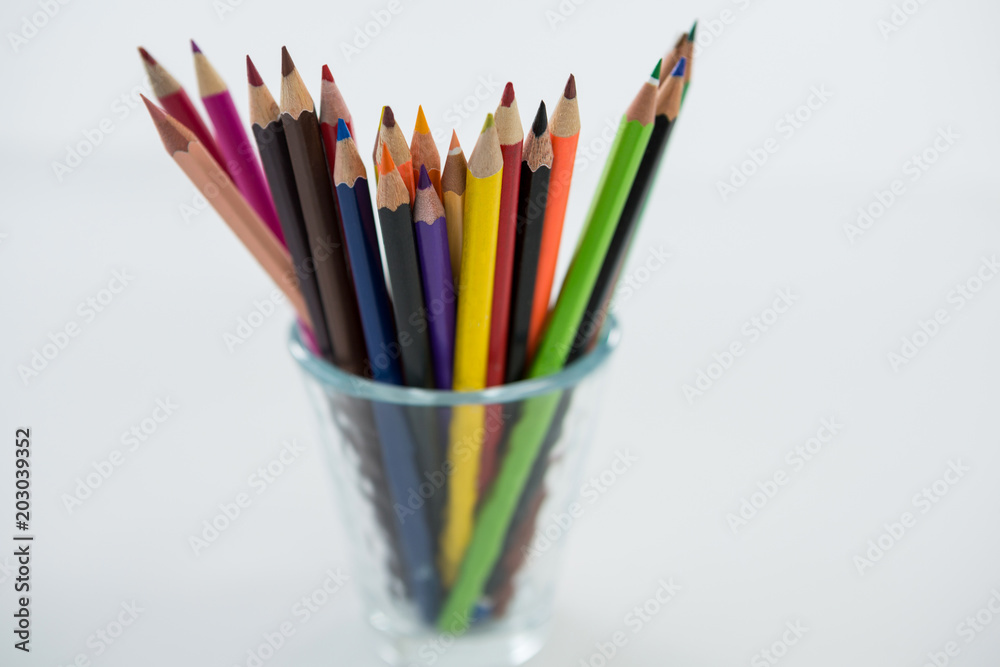 Colored pencils kept in glass on white background Colored pencils kept in glass on white background