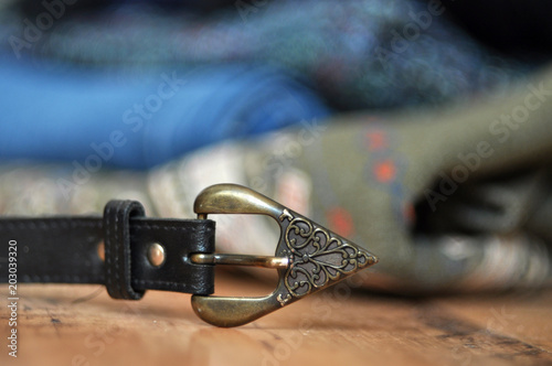 Vintage metal buckle on leather belt close-up.