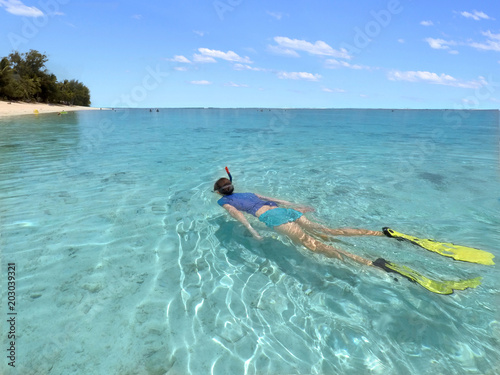 Young woman snorkelling  in a lagoon in Rarotonga Cook Islands