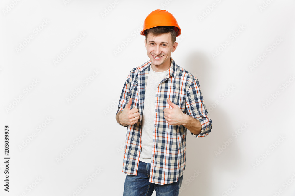 Young smiling handsome man in casual clothes and protective construction orange helmet showing thumbs up isolated on white background. Accessories for renovation apartment room. Repair home concept. Young smiling handsome man in casual clothes and protective construction orange helmet showing thumbs up isolated on white background. Accessories for renovation apartment room. Repair home concept.