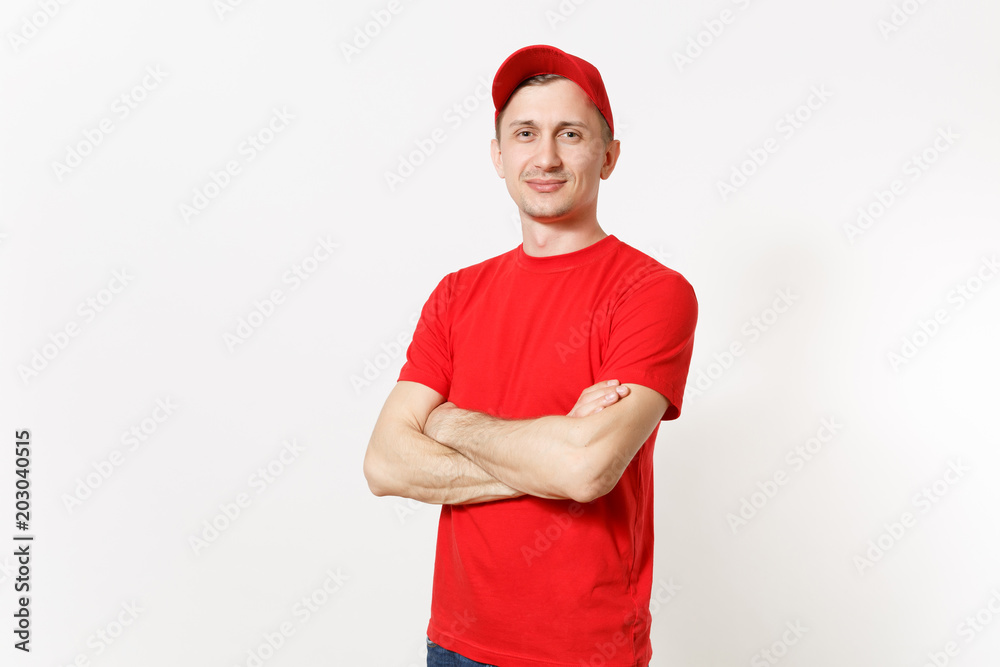 Delivery man in red uniform isolated on white background. Professional calm caucasian male in cap, t-shirt working as courier or dealer, holding hands crossed folded. Copy space for advertisement. Delivery man in red uniform isolated on white background. Professional calm caucasian male in cap, t-shirt working as courier or dealer, holding hands crossed folded. Copy space for advertisement.