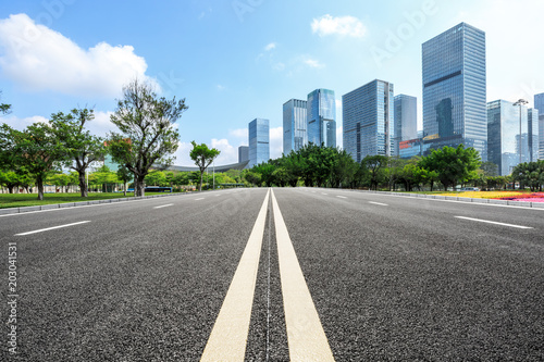 empty asphalt road and modern commercial office buildings © ABCDstock