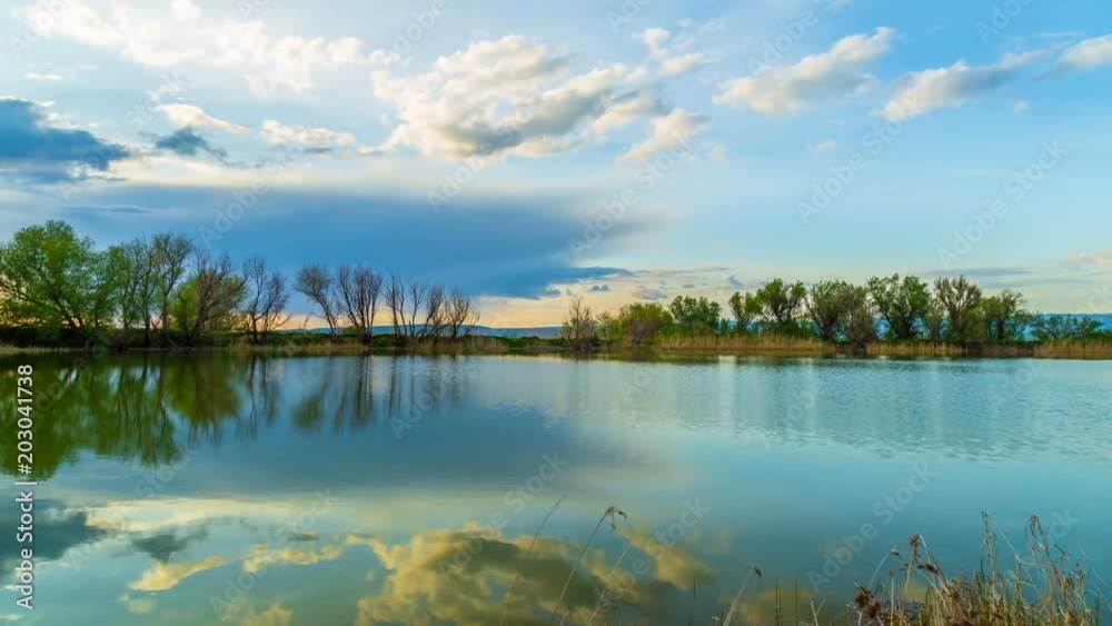 Reflection of clouds in the lake at sunset. TimeLapse 4K. Michigan USA Reflection of clouds in the lake at sunset. TimeLapse 4K. Michigan USA