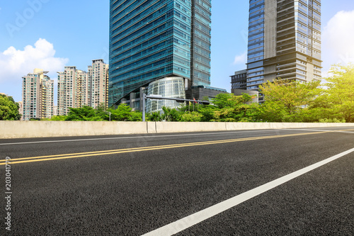 empty asphalt road and modern commercial buildings © ABCDstock
