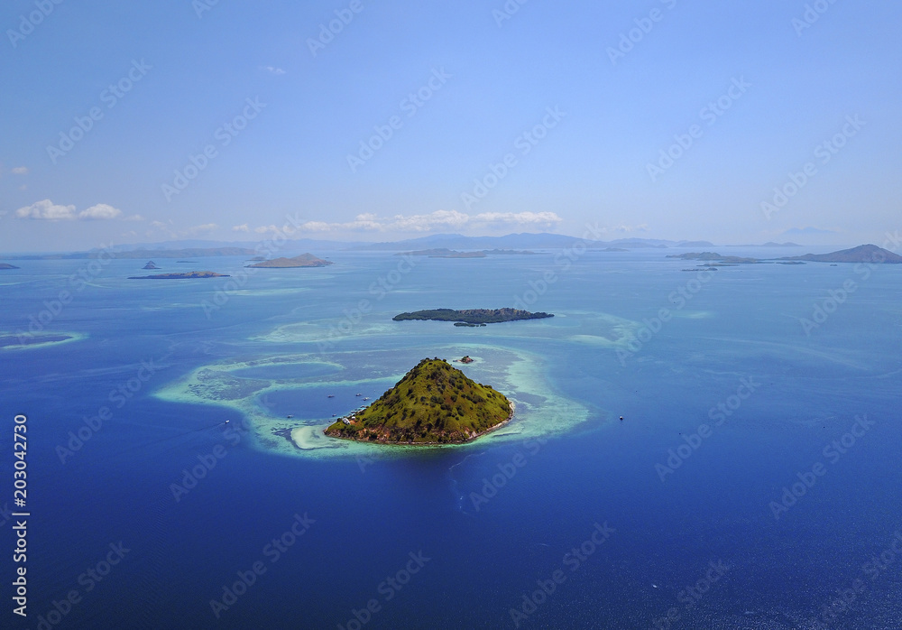 Small tropical island in the ocean, Maldives. Shot was taken from seaplane. Small tropical island in the ocean, Maldives. Shot was taken from seaplane.
