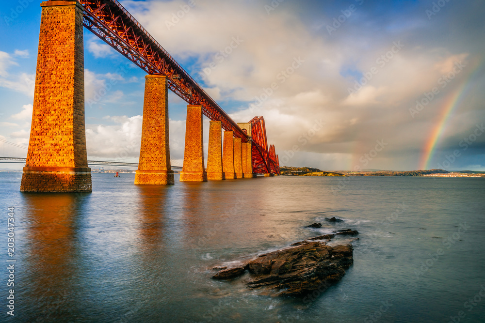 Double rainbow in the glowing sunset light at the Forth Rail bridge in Edinburgh, Scotlan,d