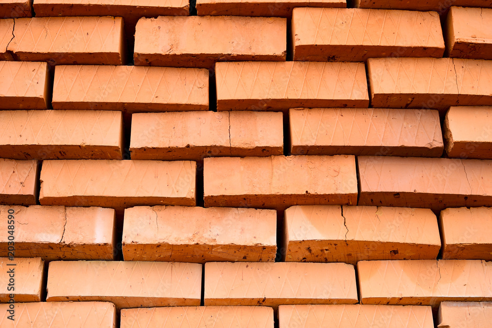Fototapeta premium Rows of red bricks ready for transport. Background.