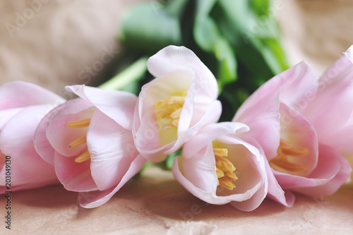 Bouquet of pink tulips on brown crumpled paper background, Happy mother's day.