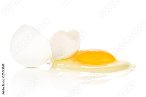 One cracked white chicken egg isolated on white background two pieces of shell and raw fresh yolk.