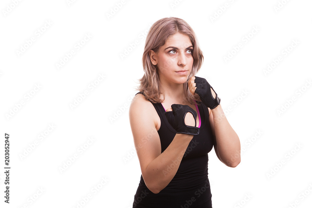 Woman in sport clothes with her fists up isolated on white background Woman in sport clothes with her fists up isolated on white background
