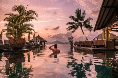 young man at the beach during vacation at the tropical islands of the Seychelles