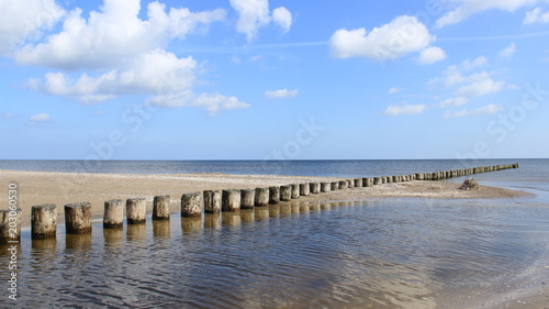 Fototapeta Naklejka Na Ścianę i Meble -  Baltic Sea During Springtime With wooden Groynes And Reflection