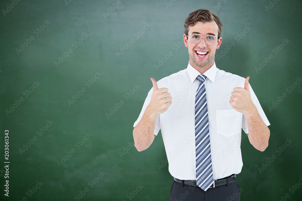 Happy geeky businessman with thumbs up against green chalkboard Happy geeky businessman with thumbs up against green chalkboard