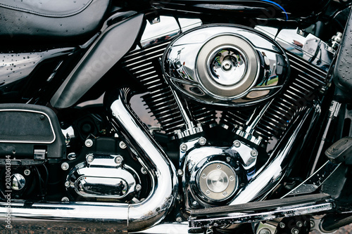 Closeup of motorbike with lots of chrome details. Modern powerful perfomance road motorcycle shiny reflexive surface engine with exhaust pipes.  Vehicle industry.  Two-wheeled vehicle technologies.