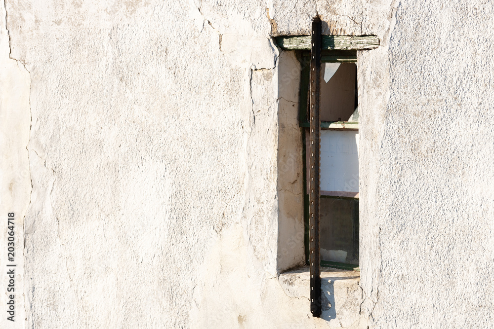 Secured window on abandoned building Secured window on abandoned building