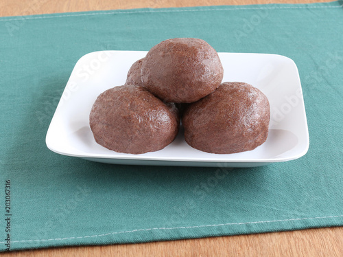 Ragi or finger millet balls, which are a healthy southern Indian food, in a ceramic tray.