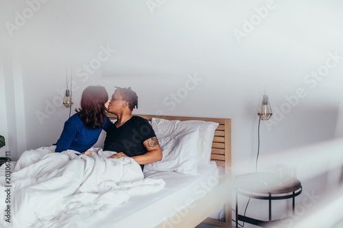 Romantic couple kissing in bed