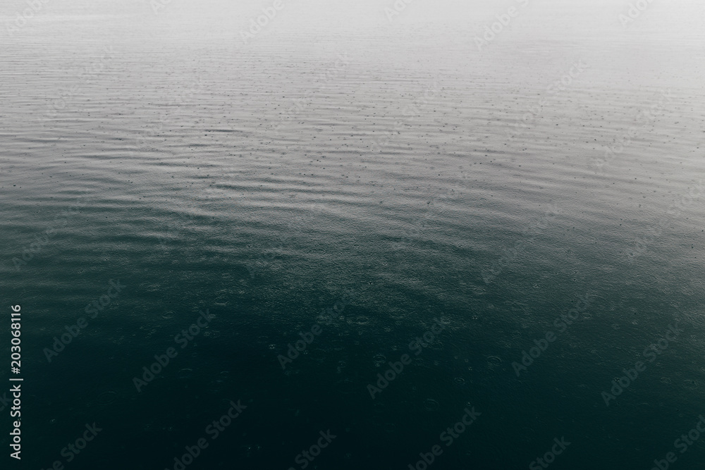 Abstract of water with raindrops falling