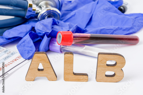 ALB Medical laboratory test acronym or abbreviation of serum albumin, blood proteins. Letters of ALB are near laboratory test tubes with blood, stethoscope, protection gloves and blood test result  photo