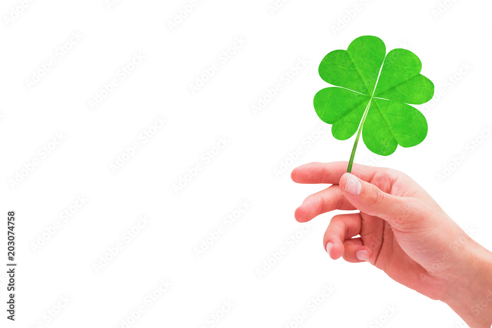 Shamrock against hand with raised fingers