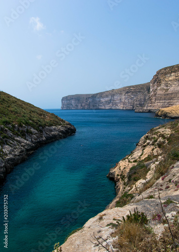 Faraway cliffs on a sunny day with calm sea © Mark