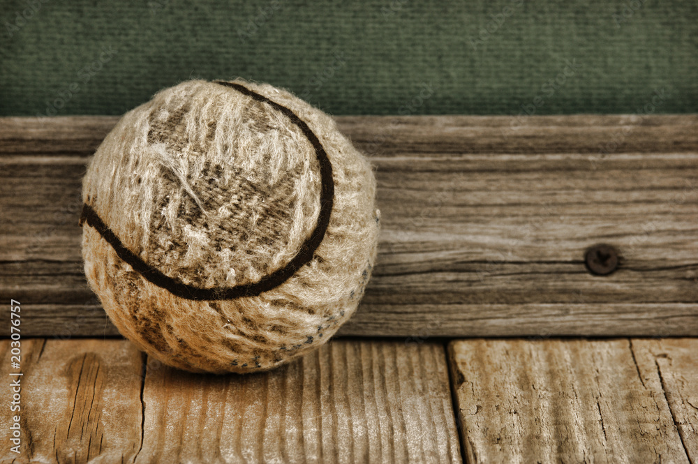 old tennis ball on a wooden floor