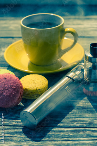 Still life with e-cig and jiuce on the wooden background photo