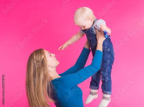 Funny family on pink background. Mother and her daughter girl. Mom and child are having fun.