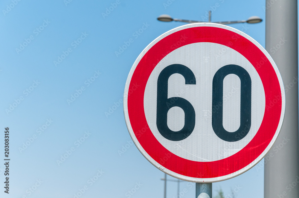 Traffic speed limit sign for restriction on 60 kilometers or miles per hour with blue sky background Traffic speed limit sign for restriction on 60 kilometers or miles per hour with blue sky background