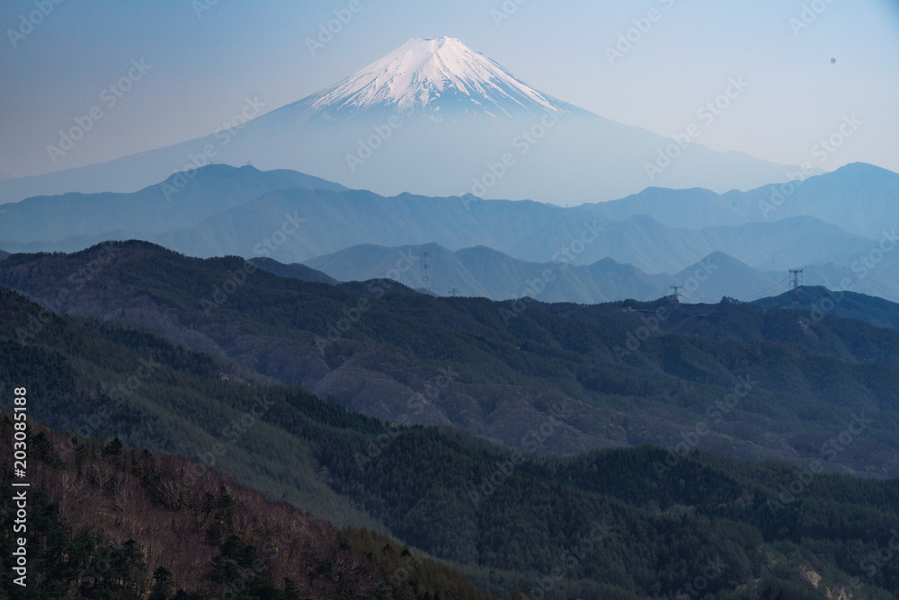 Mysterious Mt. Fuji rises from a mountain range. Mysterious Mt. Fuji rises from a mountain range.