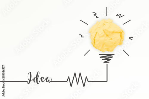 Creativity inspiration, ideas and innovation concepts with lightbulb and paper crumpled ball.