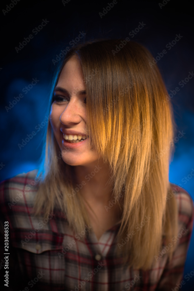 portrait smiling girl on blue background in studio portrait smiling girl on blue background in studio