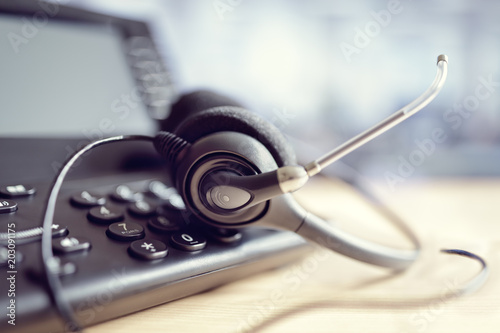 Headset headphones and telephone in call center photo