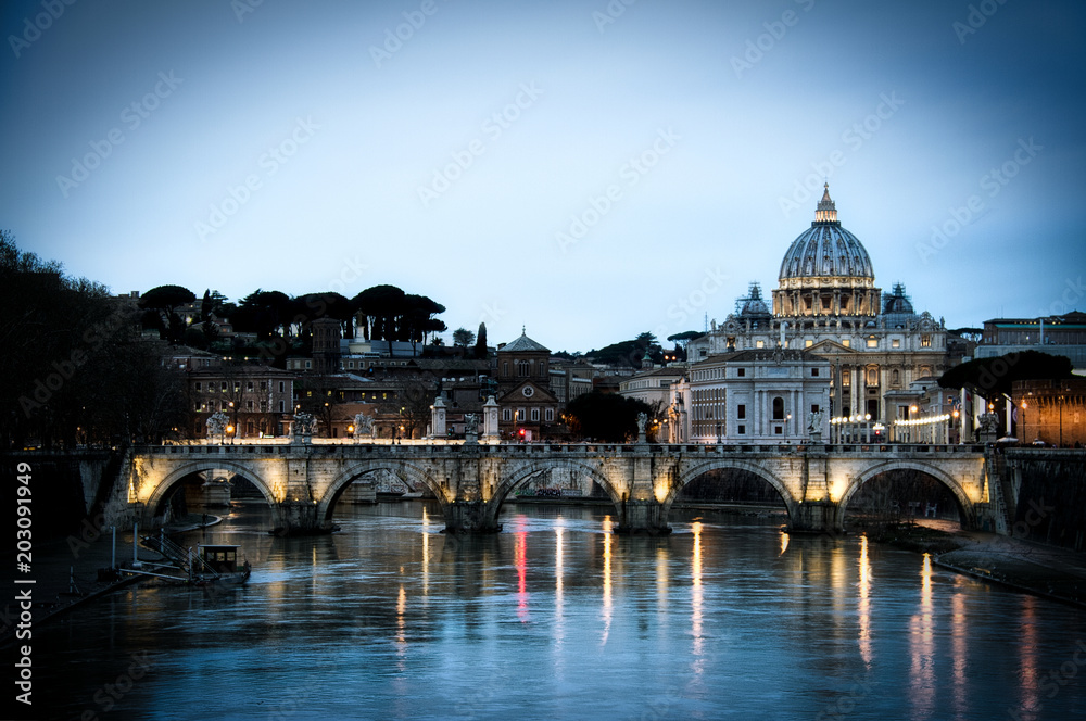 View of the Tiber River in Rome with the Vatican and St. Peter’s Basilica in the background with a vignette.