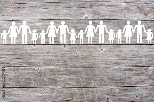 Paper white families on wooden background
