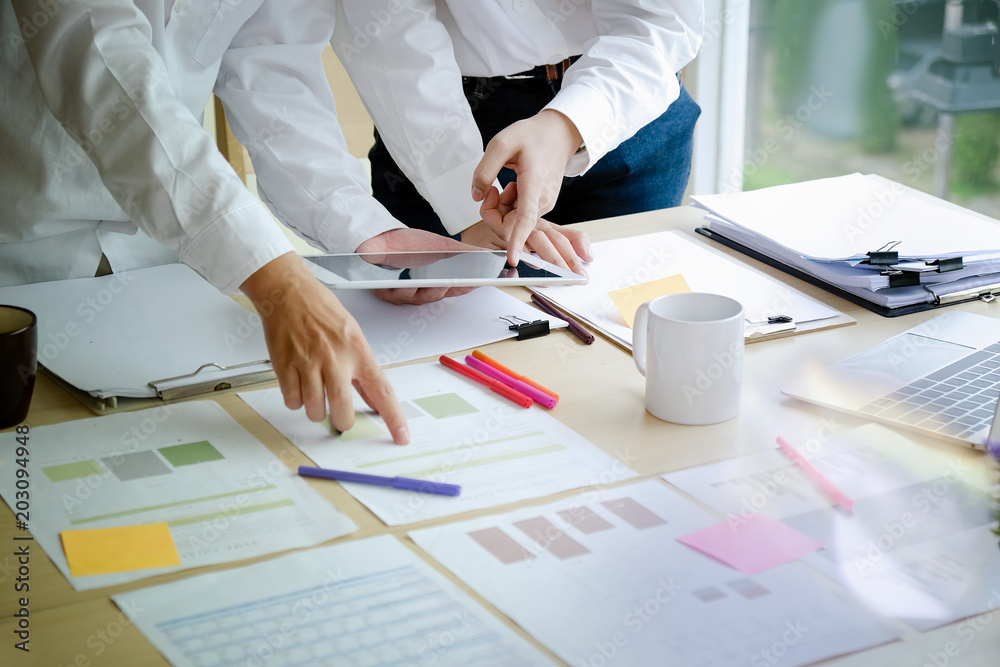 Business corporate two colleagues discussing and design on paperwork on desk. co-workers concept. Business corporate two colleagues discussing and design on paperwork on desk. co-workers concept.
