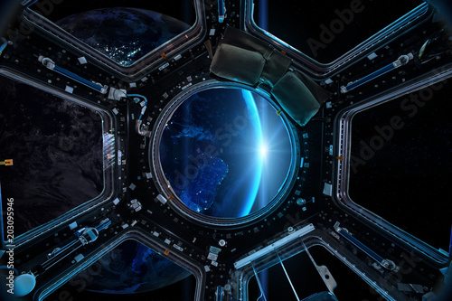 Fototapeta Naklejka Na Ścianę i Meble -  View from a porthole of space station on the Earth background. Elements of this image furnished by NASA.