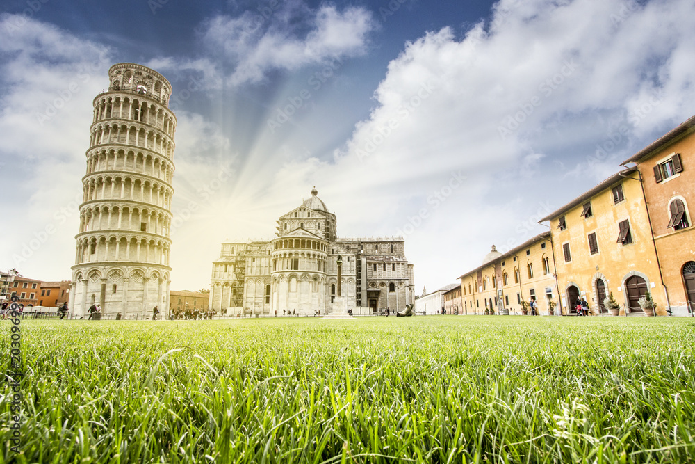 TOP ATTRACTION OF ITALY.  LEANING TOWER OF PISA WITH BASILICA IN SUNSET LIGHT