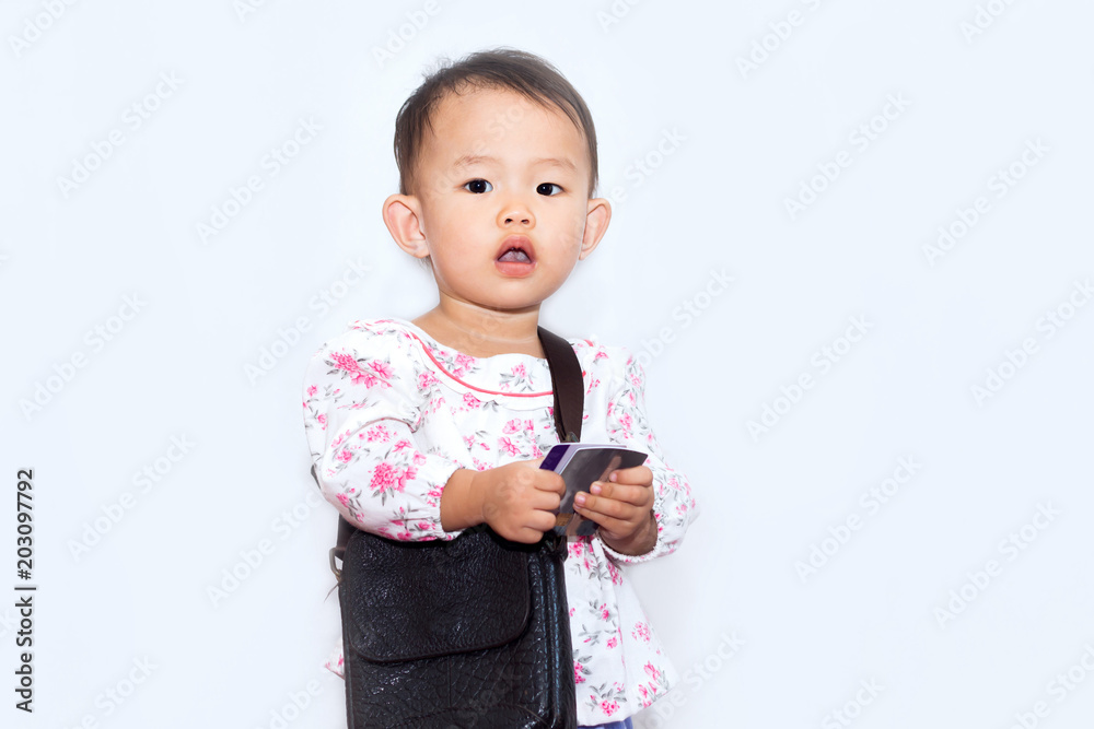 Nice little girl with bag holding credit card for shopping on white background Nice little girl with bag holding credit card for shopping on white background