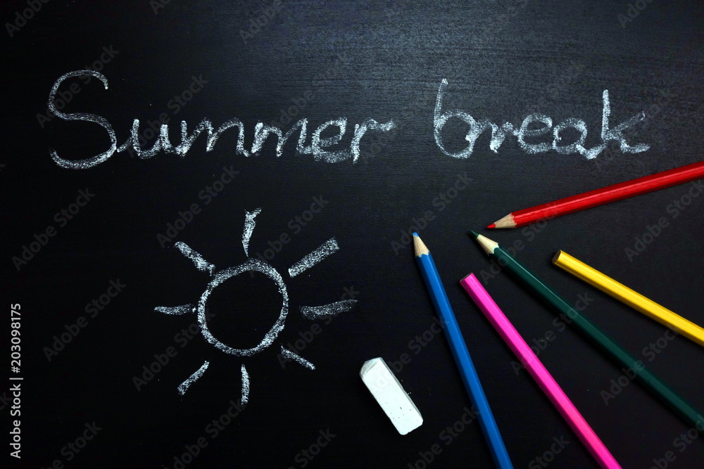 Summer break text and sun drawing on chalkboard, end of school year concept Summer break text and sun drawing on chalkboard, end of school year concept