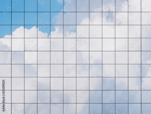 Fototapeta Naklejka Na Ścianę i Meble -  View of the clouds reflected in the glass office building. 3d rendering