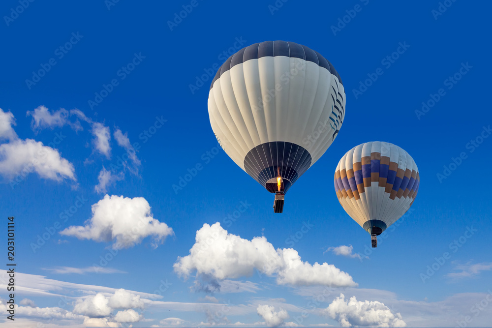Fototapeta premium Two hot air balloons flying in sunsrise sky Cappadocia, Turkey, close-up, bottom