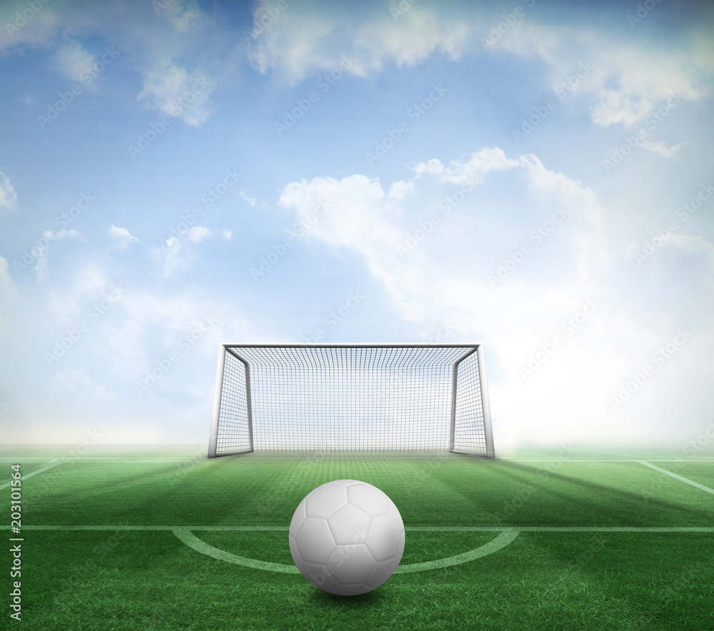 Digitally generated white leather football against football pitch and goal under blue sky