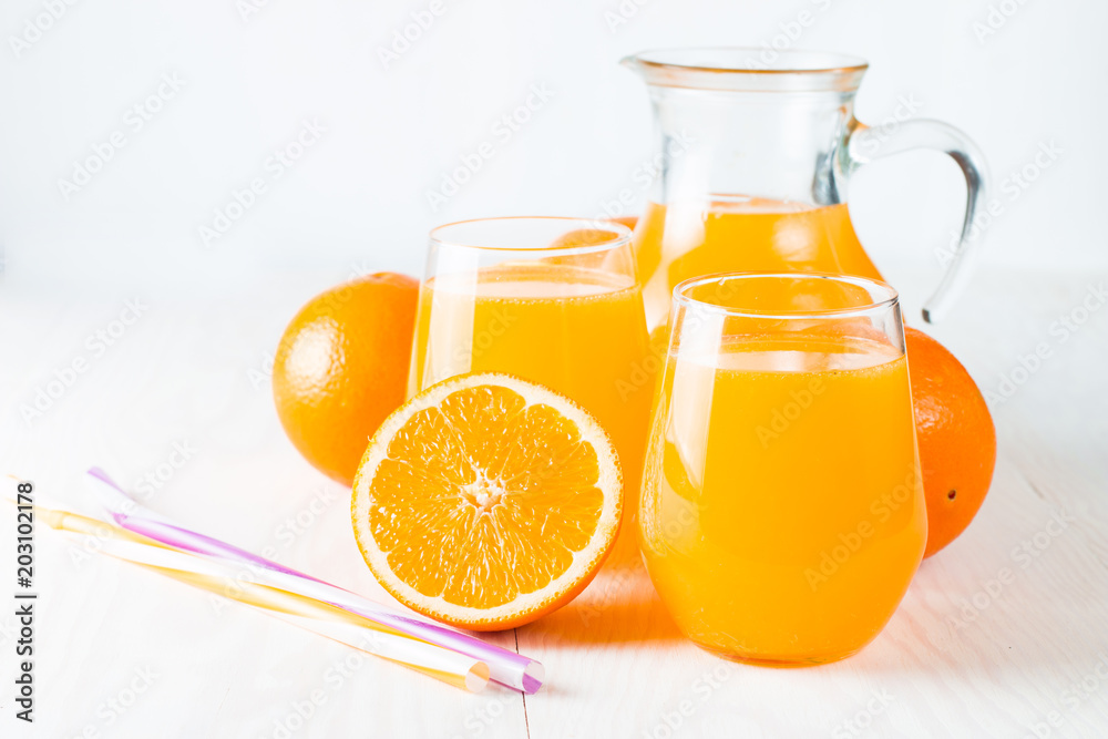 Close-up of a glass of orange juice with oranges fruits on wooden and stone background. Vitamins and minerals. Healthy drink and beverage concept. Close-up of a glass of orange juice with oranges fruits on wooden and stone background. Vitamins and minerals. Healthy drink and beverage concept.