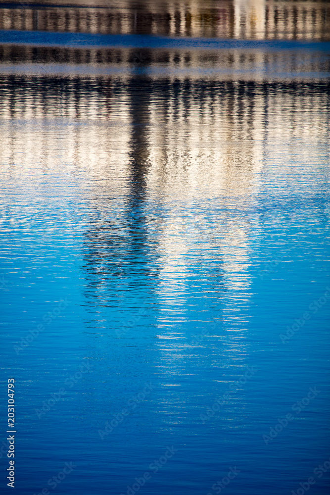 Reflection of a building on the smooth surface of water as a background