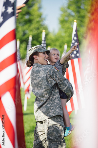 American Female soldier with a little girl