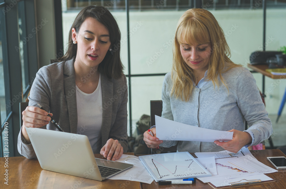 Fototapeta premium two attractive colleague business woman adviser working with teamwork together discussion planning to complete and successful project.