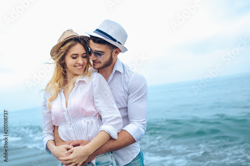 Lovers couple in love having fun dating on beach.