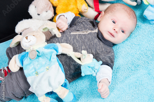 Cute newborn baby lying with a toy teddy bear