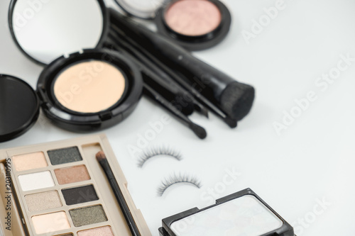 isolated cosmetic object, powder, brush and eyelash on white background with copy space. image for beauty, business, makeup, cosmetic, makeup concept
